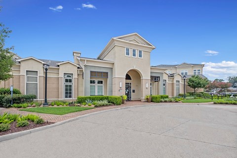 the front of a building with a driveway and walkway the front of a building with a driveway and walkway at The Millennium Towne Center Apartments, Baton Rouge